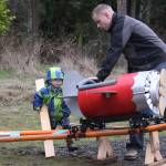 Scott Brazelton and his 3-year-old son Wyatt get the roller coaster cart in position to launch at their property in Oak Harbor Wednesday, March 1, 2017. Brazelton, a Navy pilot, built a roller coaster from scratch for his son. Photo by Ron Newberry/Whidbey News-Times