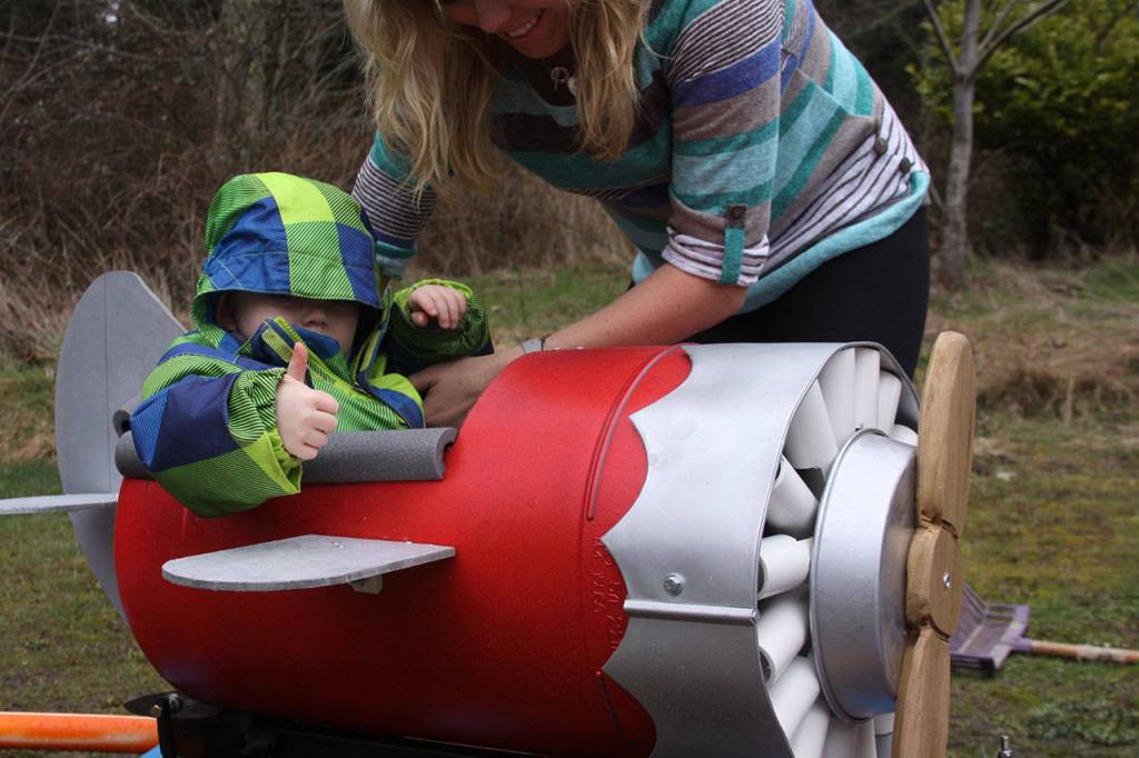 Wyatt Brazelton gives a thumbs-up while his mother Brittany straps him in before take-off of his roller coaster cart Wednesday, March 1, 2017. Photo by Ron Newberry/Whidbey News-Times