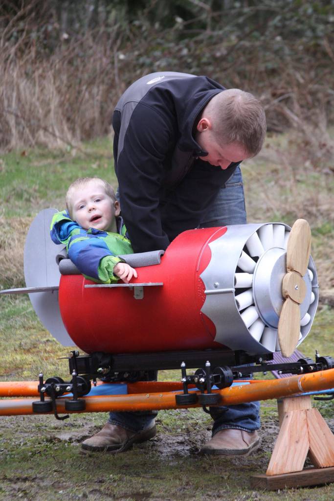 Scott Brazelton does a safety check before his son Wyatt goes on a ride around the roller coaster track Wednesday, March 1, 2017. Photo by Ron Newberry/Whidbey News-Times