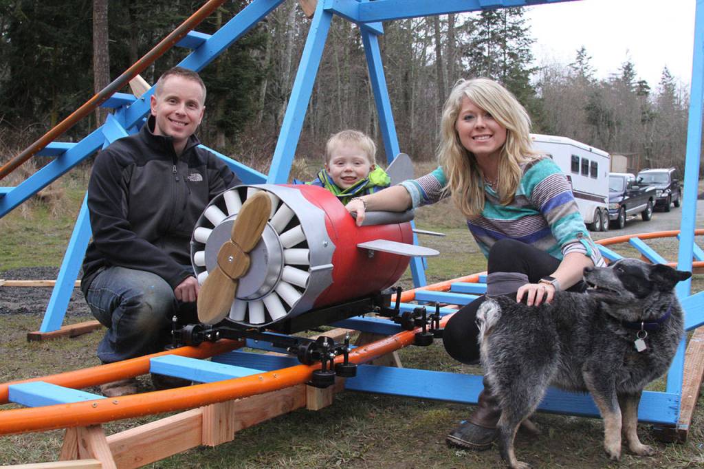 Scott and Brittany Brazelton pose near their home-made roller coaster, with son Wyatt and dog Allie Wednesday, March 1, 2017 at their Oak Harbor home. Photo by Ron Newberry/Whidbey News-Times