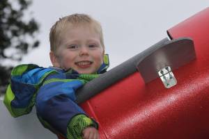 Wyatt Brazelton, 3, is all smiles as he prepares to go on a ride around the roller coaster that his father built for him in their Oak Harbor backyard Wednesday, March 1, 2017. Photo by Ron Newberry/Whidbey News-Times