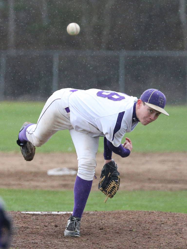 Trent Benson fires a pitch through the rain drops Wednesday. (Photo by John Fisken)