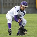 Oak Harbor left fielder Caleb Fitzgerald looks in a ground ball against Marysville-Pilchuck. (Photo by John Fisken)