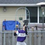 Oak Harbor left fielder Caleb Fitzgerald looks in a fly ball Friday. (Photo by John Fisken)