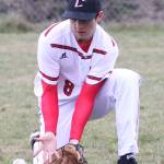 Outfielder Ethan Marx scoops out a ground ball against Sequim. (Photo by John Fisken)
