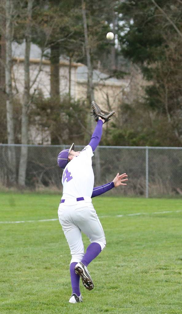 Oak Harbor first baseman Steven Richards runs down a pop up in foul territory. (Photo by John Fisken)