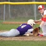 Oak Harbor&rsquo;s Steven Richards dives safely back to first base as Marysville-Pilchuck&rsquo;s Kyler Alvis awaits the pickoff throw. (Photo by John Fisken)