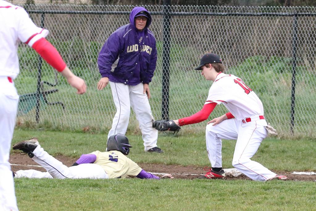 Kory Score puts the tag on a Sequim base runner. (Photo by John Fisken)