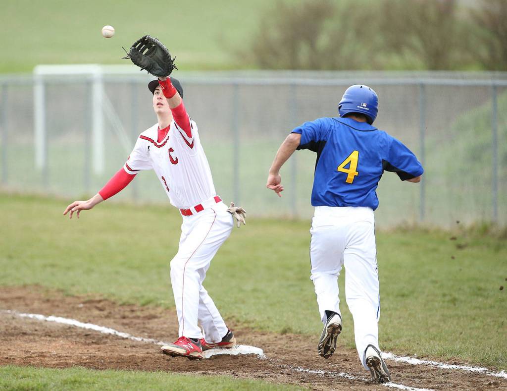 Coupeville&rsquo; Kory Score takes a throw at first base to force out Bremerton&rsquo;s Desmond Moore. (Photo by John Fisken)