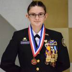 Elena Flake displays her medal from the national competition. (Photo by Civil Marksmanship Program)