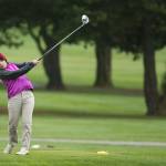 Jessica Monaghan follows through on a tee shot for Oak Harbor. (Photo by John Fisken)