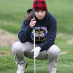 Jessica Monaghan examines the green Tuesday afternoon. (Photo by John Fisken)