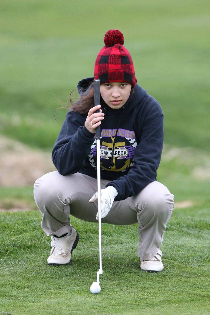 Jessica Monaghan examines the green Tuesday afternoon. (Photo by John Fisken)