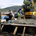 Staff from Deception Pass State Park works on an amphitheater stage project Thursday. They&rsquo;re building the foundation for the stage that will serve visitors who come to watch entertainment at the amphitheater this summer. Park manager Jack Hartt, left, listens to details from a staff member. Photo by Ron Newberry/Whidbey News-Times