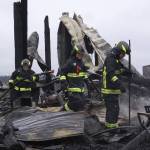 Firefighters with Central Whidbey Fire & Rescue look for hot spots Tuesday morning at Willowood Farm on Central Whidbey. A fire Monday night destroyed the historic Smith Barn. As of Tuesday morning, a cause had not been determined. Photo by Ron Newberry/Whidbey News-Times