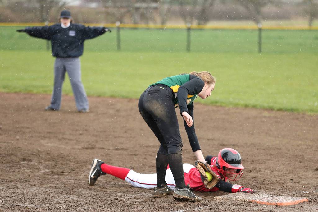 Umpire Rita Cline calls Coupeville&rsquo;s Tamika Nastali safe as she slides in under the tag of Vashon Island&rsquo;s Abby Lawson. (Photo by John Fisken)