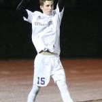 Josh Coe puts the ball in play for the Wildcats. (Photo by John Fisken)
