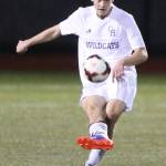 Seth Gluth passes for the Wildcats in Tuesday&rsquo;s match. (Photo by John Fisken)
