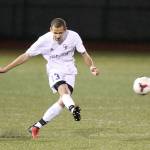 Taylor Jackson boots the ball for Oak Harbor in Tuesday&rsquo;s match. (Photo by John Fisken)