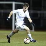 Oak Harbor&rsquo;s Kegan Snell runs down the ball during the Jackson match. (Photo by John Fisken)