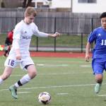 Kurtis Zylstra beats South Whidbey&rsquo;s Graham Colar to the ball. (Photo by John Fisken)