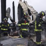 Firefighters with Central Whidbey Fire & Rescue look for hot spots Tuesday morning at Willowood Farm on Central Whidbey. A fire Monday night destroyed the historic Smith Barn. As of Tuesday morning, a cause had not been determined. Photo by Ron Newberry/Whidbey News-Times