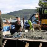 Staff from Deception Pass State Park works on an amphitheater stage project Thursday. They&rsquo;re building the foundation for the stage that will serve visitors who come to watch entertainment at the amphitheater this summer. Park manager Jack Hartt, left, listens to details from a staff member. Photo by Ron Newberry/Whidbey News-Times