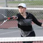 Payton Aparicio returns a shot in her first doubles win. (Photo by John Fisken)