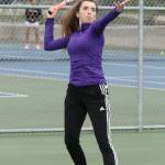 Tamia Rios serves on the way to winning the first singles match. (Photo by John Fisken)