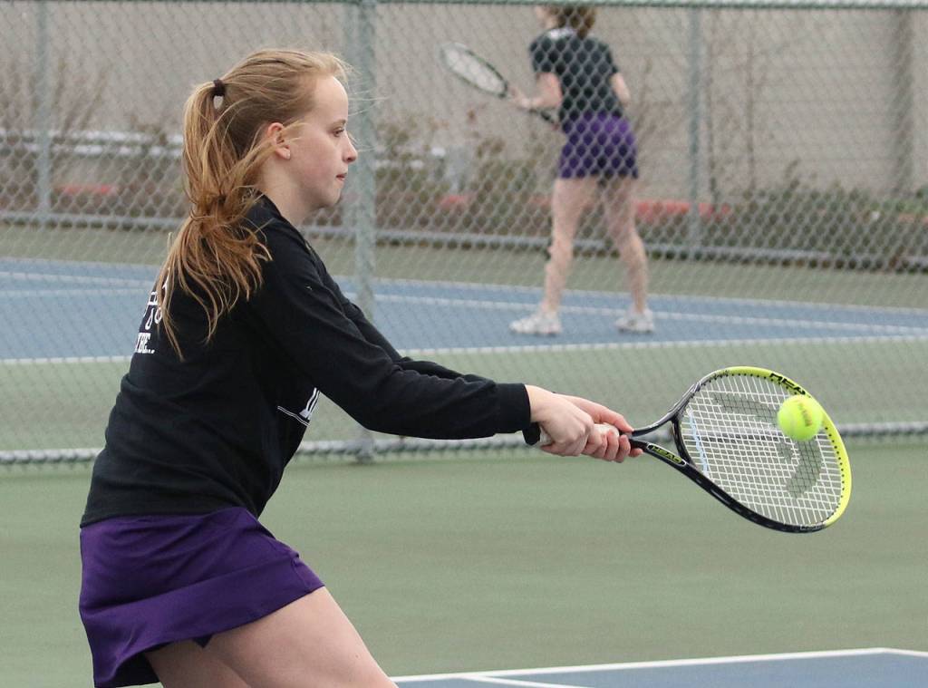 Chloe Stewell hits a backhand during second doubles. (Photo by John Fisken)