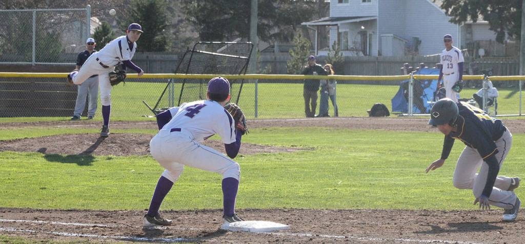 Trent Benson throws to Steven Richards in an attempt to pick off Everett&rsquo;s Michael Larson. (Photo by Jim Waller)