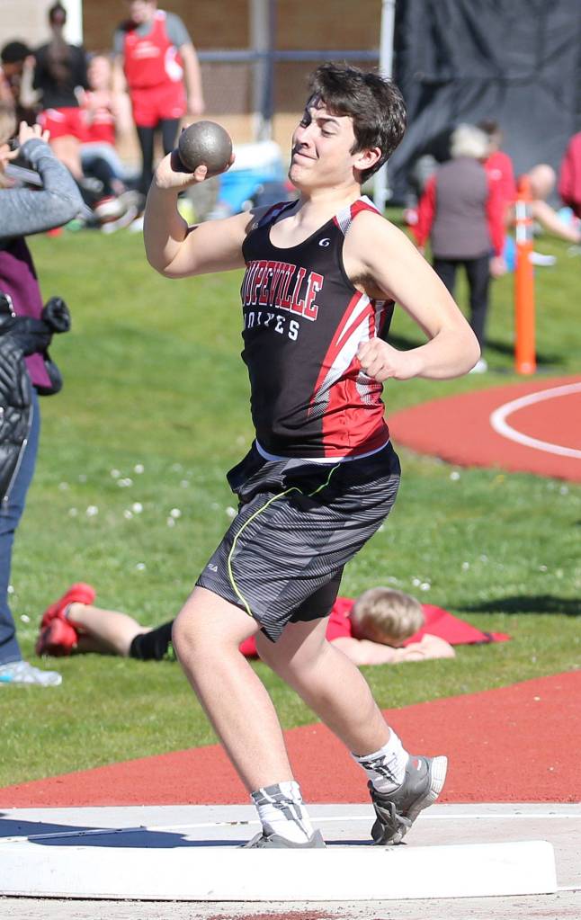 Trevor Bell tosses the shot put. (Photo by John Fisken)