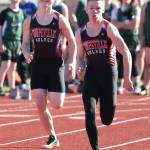 Kyle Burnett, left, and Jacob Smith head to the finish line in the 100. (Photo by John Fisken)