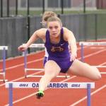 Kaitlyn Chelberg flies over a hurdle in the 300. (Photo by John Fisken)
