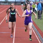 Oak Harbor&rsquo;s Jenna Cooley, right, beats the Mount Vernon runner to the finish line in the 4x400 relay. (Photo by John Fisken)
