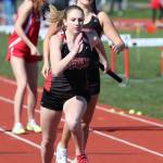 Lauren Grove takes the handoff from Lindsey Roberts in the 4x200 relay. (Photo by John Fisken)