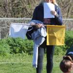 Bre Messner helps out holding sweats, flags…. (Photo by Jim Waller/Whidbey News-Times)