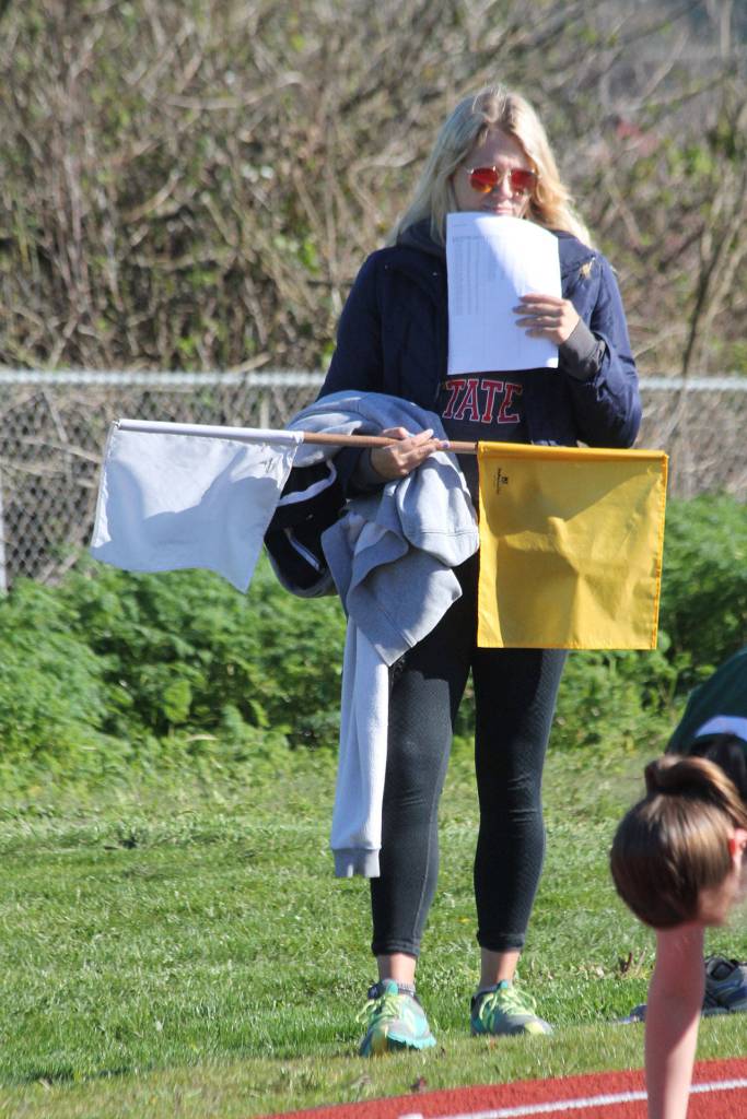 Bre Messner helps out holding sweats, flags…. (Photo by Jim Waller/Whidbey News-Times)