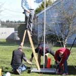 Cody Staker, top, and helpers get the finish line recorder ready. (Photo by John Fisken)