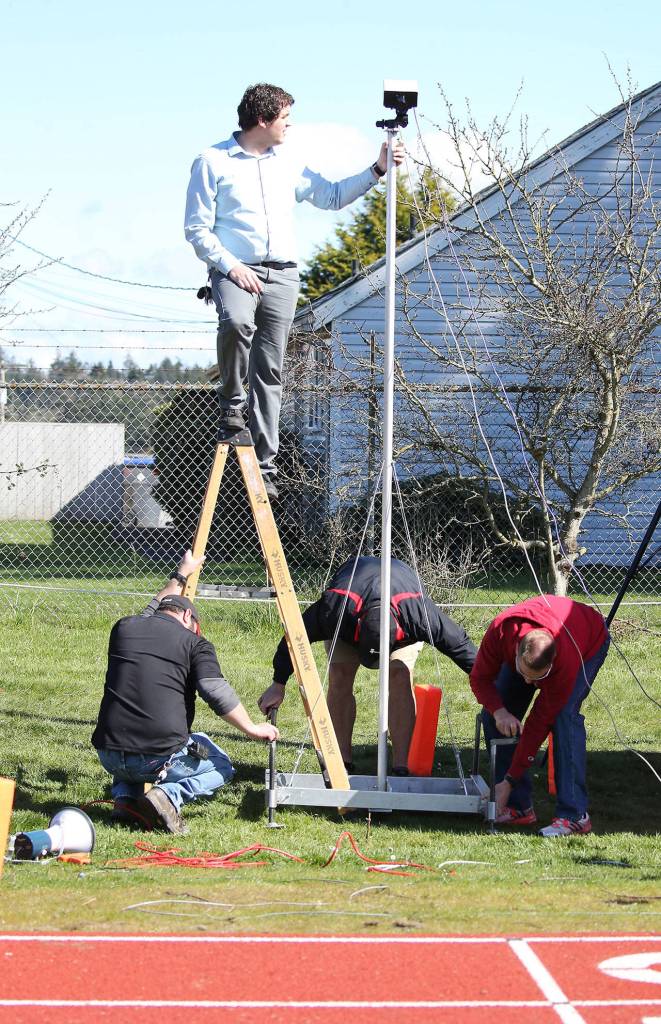 Cody Staker, top, and helpers get the finish line recorder ready. (Photo by John Fisken)