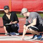 Eileen Stone, left, and Dalton Martin help with the discus competition. (Photo by John Fisken)