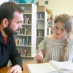 HomeConnection freshman Michelle Consolver studies her math textbook, while principal Shane Evans looks on, ready to help. Photo by Daniel Warn/Whidbey News-Times