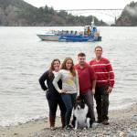 Terica and Brett Ginther with children Brooklyn Taylor and Austin Taylor all are part of the Deception Pass Tours team. They stand on the beach at Deception Pass State Park in front of their boat in 2015. Photo courtesy Terica Ginther.