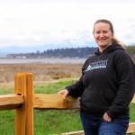 Jessica Larson, a land steward with the Whidbey Camano Land Trust, stands before a split-rail fence Thursday, Aprl 6, 2018 that was installed in March to keep duck hunters and others from parking on the property near Crockett Lake in Central Whidbey. The land trust purchased the 85-acre property from a private landowner in December on the lake&rsquo;s northeast corner to protect it and its abundant species of birds as part of the 423-acre Crockett Lake Wetland Preserve. The newly acquired property had been a widely used access point and place to park for waterfowl hunters for years. Photo by Ron Newberry/Whidbey News-Times