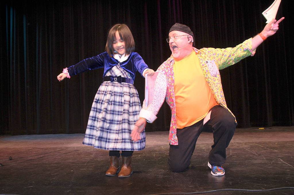 JR Russell, right, presents a prize to Grace Zhao, who gave a special performance before the presentation division got going Sunday at Oak Harbor High School for Whidbey Has Talent. Photo by Daniel Warn/Whidbey News Times