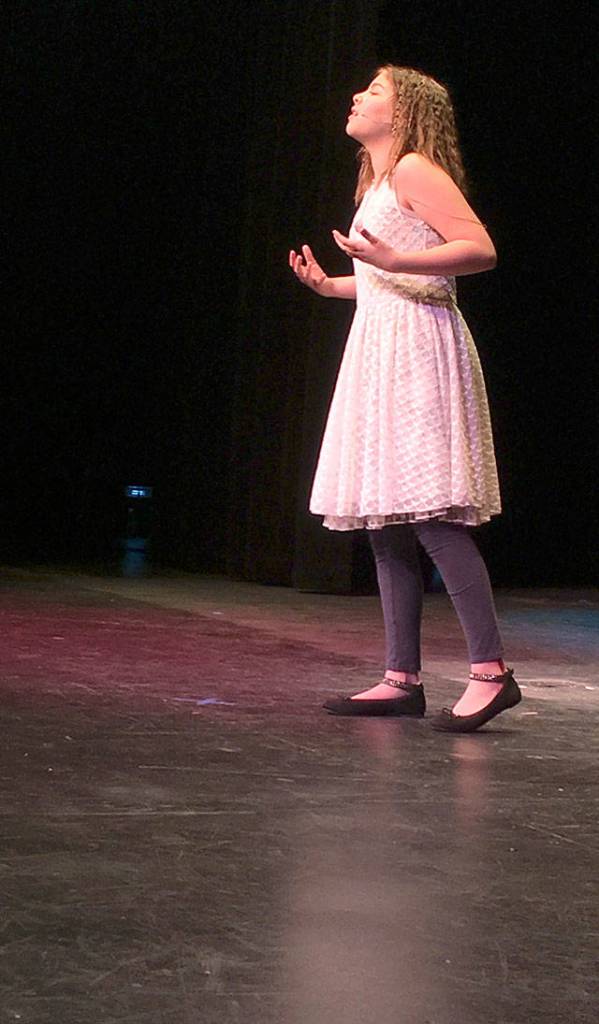 Valerie Burdt sings as part of the persentation division of Whidbey Has Talent Sunday at Oak Harbor High School. Photo by Daniel Warn/Whidbey News-Times