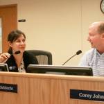 School board members Corey Johnson, left, and Ana Maria Schlecht converse in the district boardroom Thursday. Both have decided they will not seek reelection after their terms end later this year. Photo by Daniel Warn/Whidbey News-Times