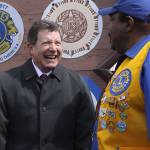 Oak Harbor Mayor Bob Severns, left, visits with Oak Harbor Lion James House in front of the city&rsquo;s welcome sign that also features the emblems of the community&rsquo;s service organizations. The Oak Harbor Lions celebrated the centennial anniversary of their parent club, Lions Clubs International, by installing a new emblem. Photo by Ron Newberry/Whidbey News-Times