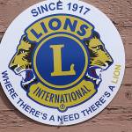 The Oak Harbor Lions installed a new emblem on Oak Harbor&rsquo;s welcome sign at the south entrance to the city in recognition of Lions Clubs International&rsquo;s centennial anniversary. Photo by Ron Newberry/Whidbey News-Times