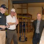Wil Shellenberger, left, president of the PBY Memorial Foundation, Mark Christopher and Jim Dever examine a crate packed with beaching gear for a PBY stored in a warehouse behind the PBY-Naval Air Museum in Oak Harbor April 6, 2017. The gear was packed in 1943 and has never been opened. Shellenberger said he&rsquo;d like to display such cases at other larger artifacts at a new hangar-style museum. Christopher and Dever will serve as emcee and auctioneer at a Celebration of Flight Dinner and Auction Saturday, May 20 at the Oak Harbor Elks Lodge. Photo by Ron Newberry/Whidbey News-Times